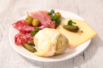 poato with raclette cheese melted, salami and bacon