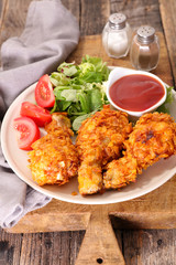 crispy chicken leg with salad and ketchup