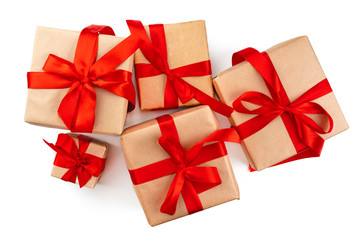 Craft christmas gifts with red bows isolated on white background, top view