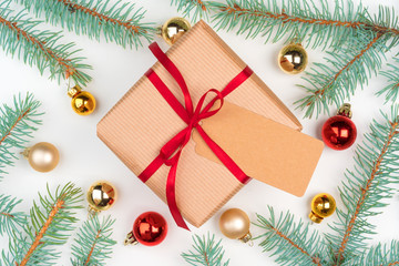 Christmas craft gift surrounded with pine tree branches and mini baubles