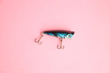 fish-shaped fishing lure on color background
