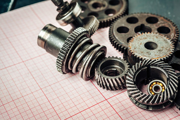 Car parts on graph paper close up. Engineering concept