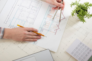 Architects working on blueprint, real estate project. Architect workplace. Construction concept....