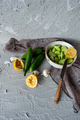 cucumber, lemon and garlic on concrete ground