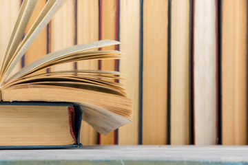 Open book, hardback books on wooden table. Back to school. Copy space