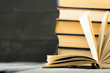 Open book, hardback books on wooden table. Back to school. Copy space