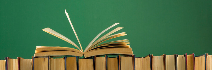 Open book, hardback books on wooden table. Back to school. Copy space