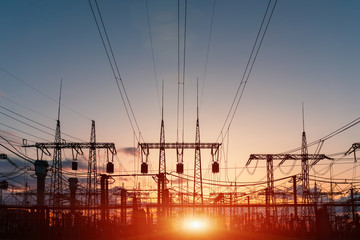 Fototapeta na wymiar Electrical substation silhouette on the dramatic sunset background