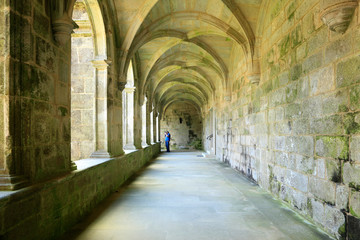 Man making a photo in arches hall in monastery cloister