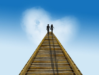 couple walking on the wooden bridge