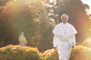 Pope walks at the end of the day in the garden       - obrazy, fototapety, plakaty