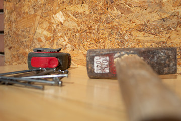 Hammer, Nails, tape measure on wood