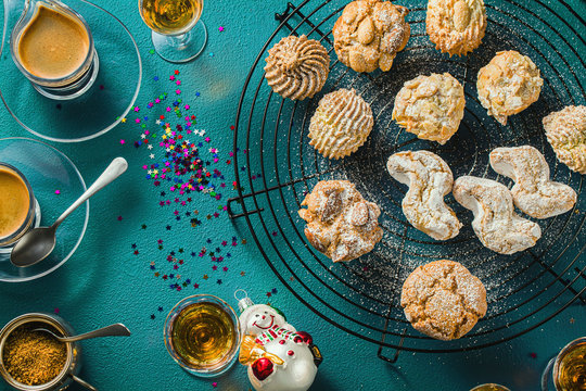 different classic Italian homemade almond cookies with espresso coffee and glasses of sweet liquor on the table, New Year's Christmas decor