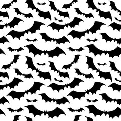 Halloween pattern. Black silhouettes of bats on a white background. Seamless vector backdrop.