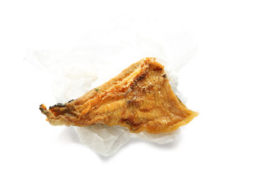 Fried fish in paper, food over white background
