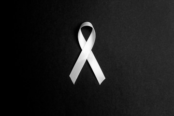 Lung cancer awareness ribbon on black background. November lung cancer awareness month.