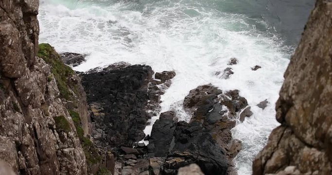 Waves breaking on coastal cliffs of Scotland.