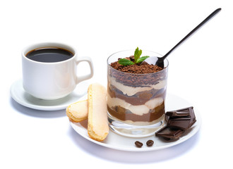 Classic tiramisu dessert in a glass, cup of coffee and pieces of chocolate on white background with clipping path