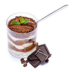 Classic tiramisu dessert in a glass cup and pieces of chocolate on white background with clipping path