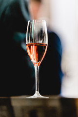 Glass with champagne lit by nightclub lights