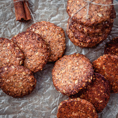 Homemade healthy oat cookies with cinnamon on brown parchment. Healthy food concept. Healthy snack. Top view