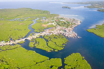 Town on the water and mangroves, top view. Coast of the island of Siargao. Tropical landscape.