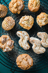 different classic Italian homemade almond cookies with espresso coffee and glasses of sweet liquor on the table, New Year's Christmas decor