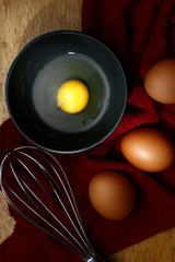 Cracked organic egg in bowl