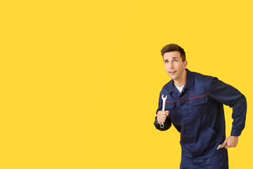 Running car mechanic on color background