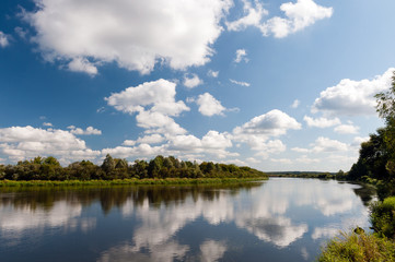 Fototapeta na wymiar River with clouds reflection