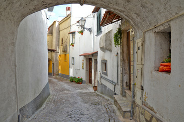Fototapeta premium Letino, Italy, 09/23/2017. A road among the old houses of a rural mountain village.