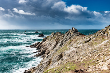 The Pointe du Raz, Brittany. This rocky cape faces the island of Sein. The giant waves of the Atlantic Ocean are shattered on the rocks and at the foot of La Vieille lighthouse.