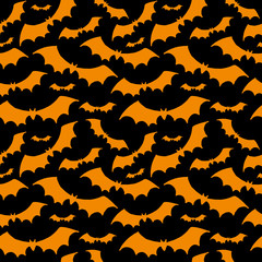 Halloween pattern. Orange silhouettes of bats on black background. Seamless vector backdrop