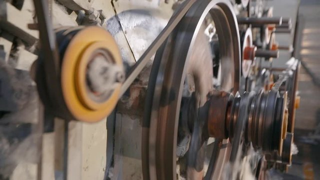 Parts rotation in a factory. Modern factory, working elements. Machine for the production of synthetic winterizer