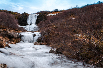 Frozen cascading waterfall from the meltwaters of Icelandic glaciers