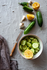 cucumber, lemon and garlic on concrete ground