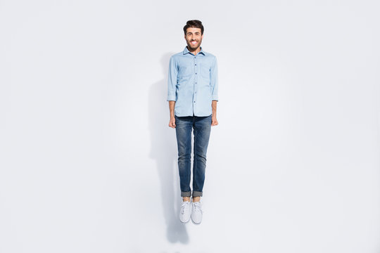 Full length photo of funny arabian guy jumping high rejoicing energetic sportive mood wear casual denim shirt isolated white color background
