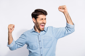 Photo of indian guy celebrating lottery winning raising arms up yelling loudly rejoicing wear...