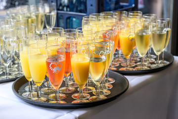 sparkling wine in glasses with orange juice in restaurant or wedding party dinner setting