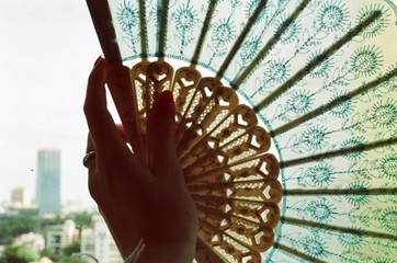 Close up of woman hand holding hand fan