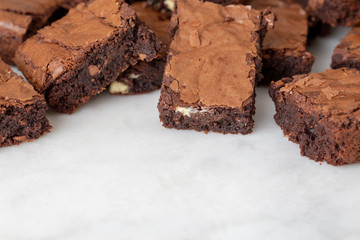 Chocolate brownies cakes on a white marble base top view looking down