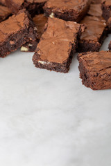 Chocolate brownies cakes on a white marble base top view looking down