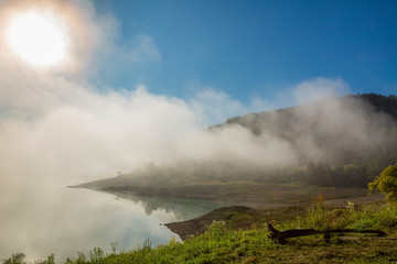 Fog over lake landscape of Zaovine lake on Tara mountain.