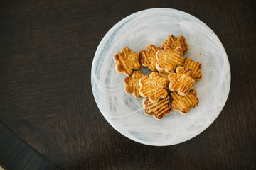 plate of sweet salted cookies on wooden floor.