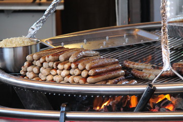 Large Sausages Cooking on a Large Outdoor Fire Grill.