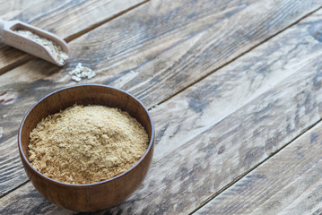 Bran oat in bowl in wooden background