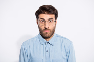 Obraz premium Close up photo of amazing indian guy looking big eyes feel guilty blamed for awful situation wear specs casual denim shirt isolated white color background