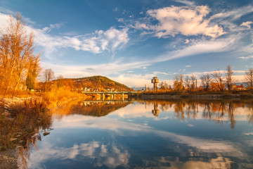 Mirroring autumn landscape in The Vah river near The Zilina town, Slovakia, Europe.