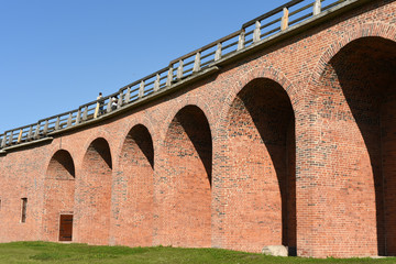 Fototapeta premium Fragment of a brick wall of the ancient Novgorod Kremlin on a summer sunny day. Veliky Novgorod