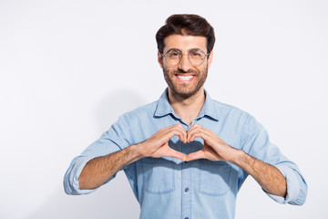 Photo of arabian guy toothy beaming smile making heart figure with fingers romance date invitation wear specs casual denim shirt isolated white color background